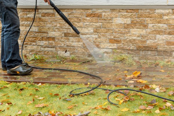 man-cleaning-street-with-high-pressure-power-washe-2025-03-11-16-50-33-utc